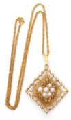 9ct gold and seed pearl pendant, a diamond shaped panel with sunburst design highlighted with six