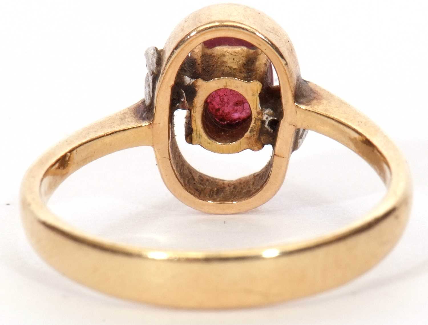 Modern ruby and diamond ring, the oval faceted ruby in an oval halo surround highlighted with two - Image 4 of 9