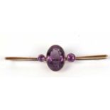 Vintage amethyst brooch, the large faceted oval shaped amethyst is 18x12mm, flanked by two small