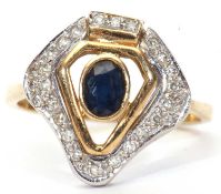 Modern sapphire and diamond designer ring, centering a dark oval faceted sapphire in an open work