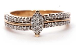 Modern 9ct gold and diamond cluster ring centering a marquise shaped diamond cluster raised above
