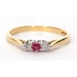 18ct gold ruby and diamond three stone ring centering a small round cut ruby flanked by two round