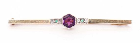 Amethyst and Emerald set brooch, the hexagonal cut amethyst flanked by two small emeralds, 5cm long