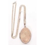 White metal oval locket, part chased and engraved with scrolls suspended from a 925 stamped chain