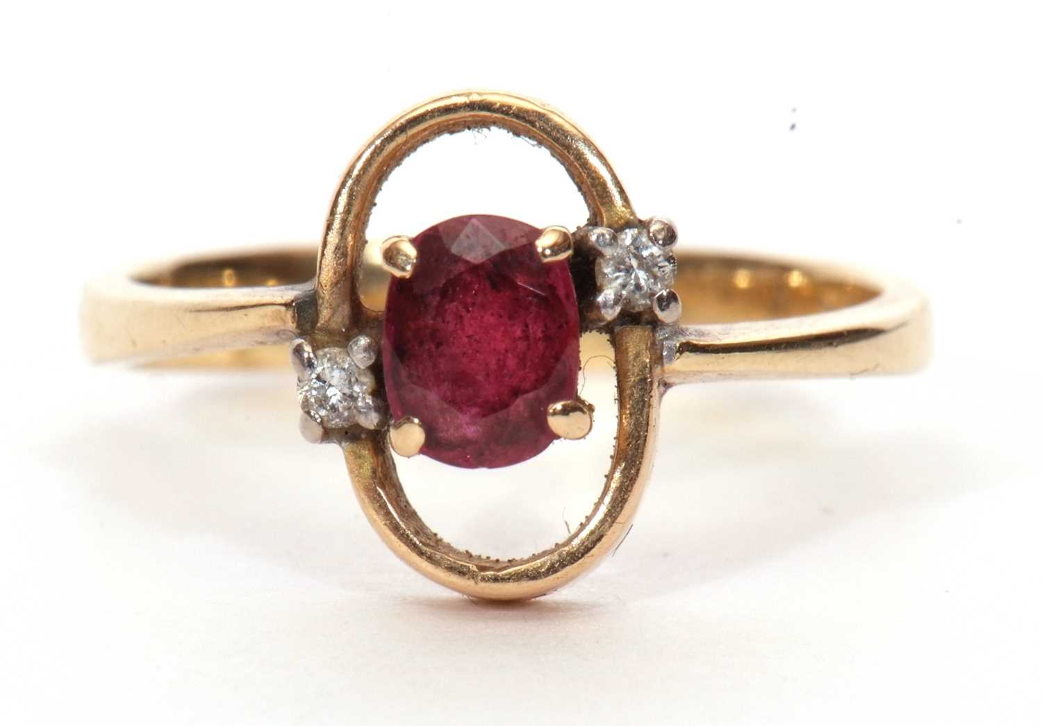 Modern ruby and diamond ring, the oval faceted ruby in an oval halo surround highlighted with two