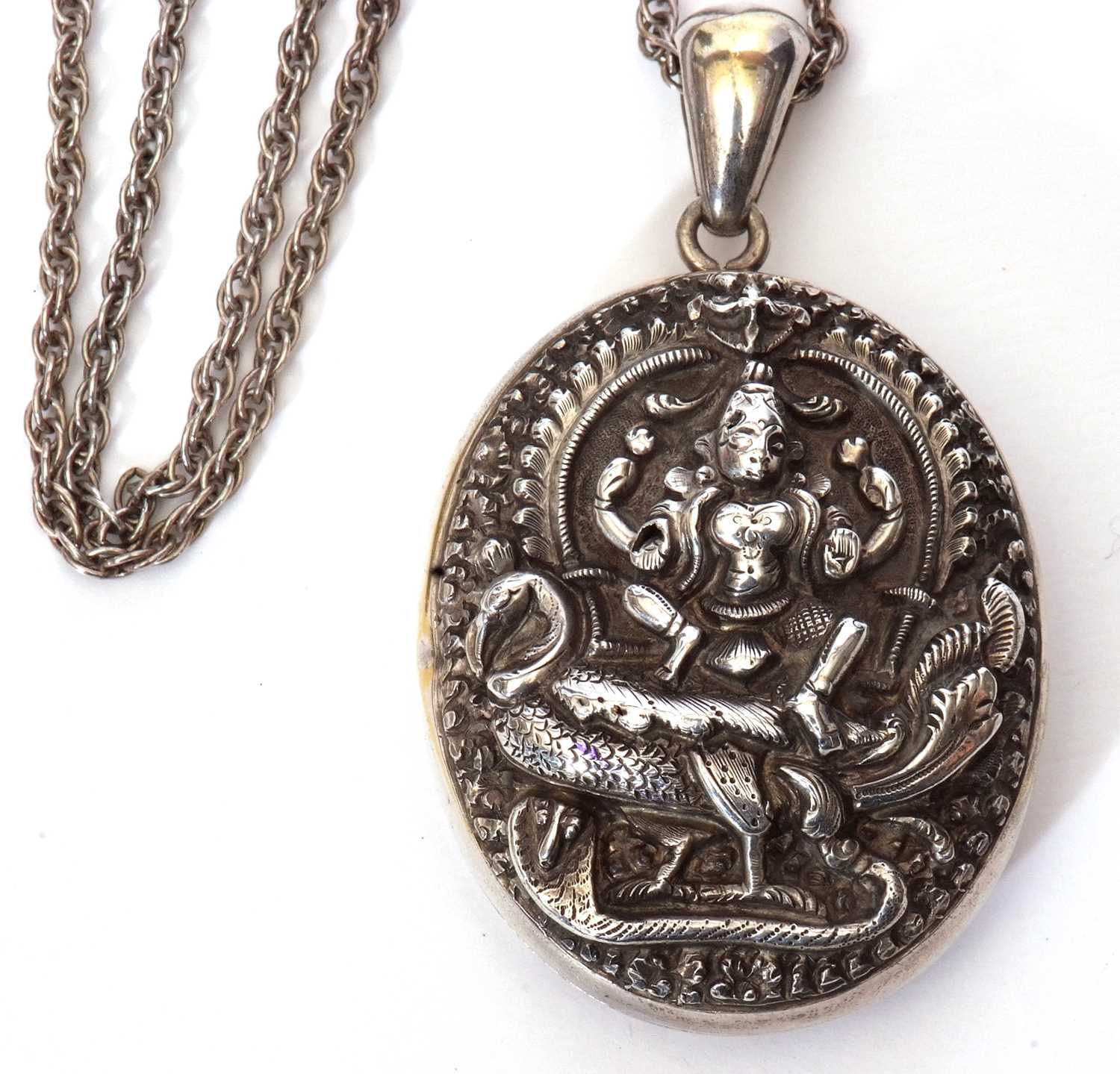 Large Indian white metal oval locket, the front elaborately decorated with a figure seated upon a - Image 2 of 5