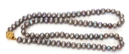 Single row of cultured fresh water grey pearls of irregular shape to a gilt metal clasp, 30cm long