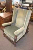 Large Carolean style wing back armchair with carved frame, 116cm high