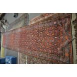 Antique caucasian runner carpet decorated with large central geometric panel principally in red