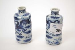Pair of Chinese porcelain scent bottles with reign marks to base, decorated with dragons chasing the