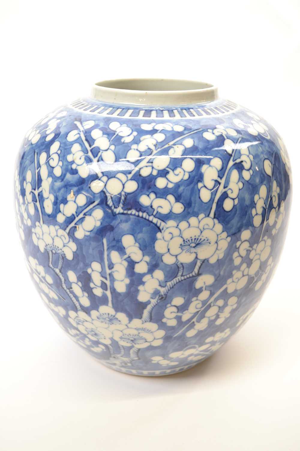 Large Chinese porcelain ginger jar decorated with prunus on a blue ground with four character mark