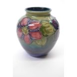 Mid 20th Century Moorcroft vase with two blind floral design on green background, 12cm high