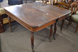 19th Century maghogany extending dining table set on turned legs with casters, 133cm wide