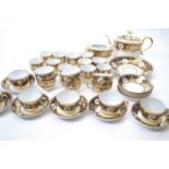 An early 19th Century New Hall or Coalport type tea set comprising twelve cups and saucers, twelve