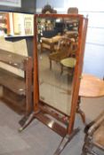 Sheraton style mahogany cheval mirror with bevelled glass and fluted side supports with brass end