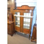 Edwardian mahogany and inlaid china display cabinet of bow front form with two lead glazed doors,