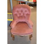 Victorian pink upholstered button back nursing chair raised on short scrolled legs, 82cm high