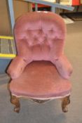 Victorian pink upholstered button back nursing chair raised on short scrolled legs, 82cm high
