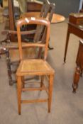 Late 19th Century hardwood framed and cane seated correction chair, 96cm high