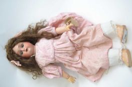 Simon & Halbig (KR) early 20th Century doll in pink dress with blue glass eyes, the bisque head