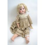 Vintage doll with blonde hair and glass eyes, marked with 5 to the rear of the bisque head
