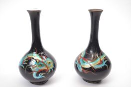 Pair of Japanese Cloisonne vases, the black ground painted in enamel colours with dragons, 15cm high
