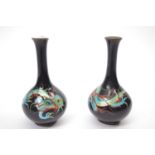 Pair of Japanese Cloisonne vases, the black ground painted in enamel colours with dragons, 15cm high