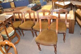 Set of six late Victorian oak framed dining chairs decorated with carved floral detail