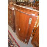 Georgian mahogany bow front two door corner cabinet with brass H shaped hinges and a shelved