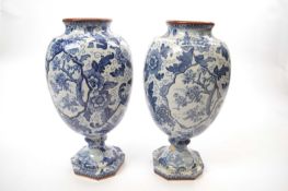 Pair of Dutch delft vases with blue printed foliage decoration, 28cm high