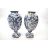 Pair of Dutch delft vases with blue printed foliage decoration, 28cm high