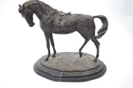Spelter model of a racehorse on oval base mounted on a black marble type base, 30cm long