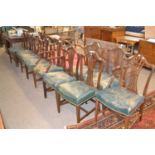 Set of ten mahogany Hepplewhite style dining chairs with pierced splat backs and worn leather seats