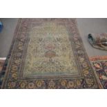 Antique Persian wool rug with tree of life design featuring a cental urn decorated in cream, blue,