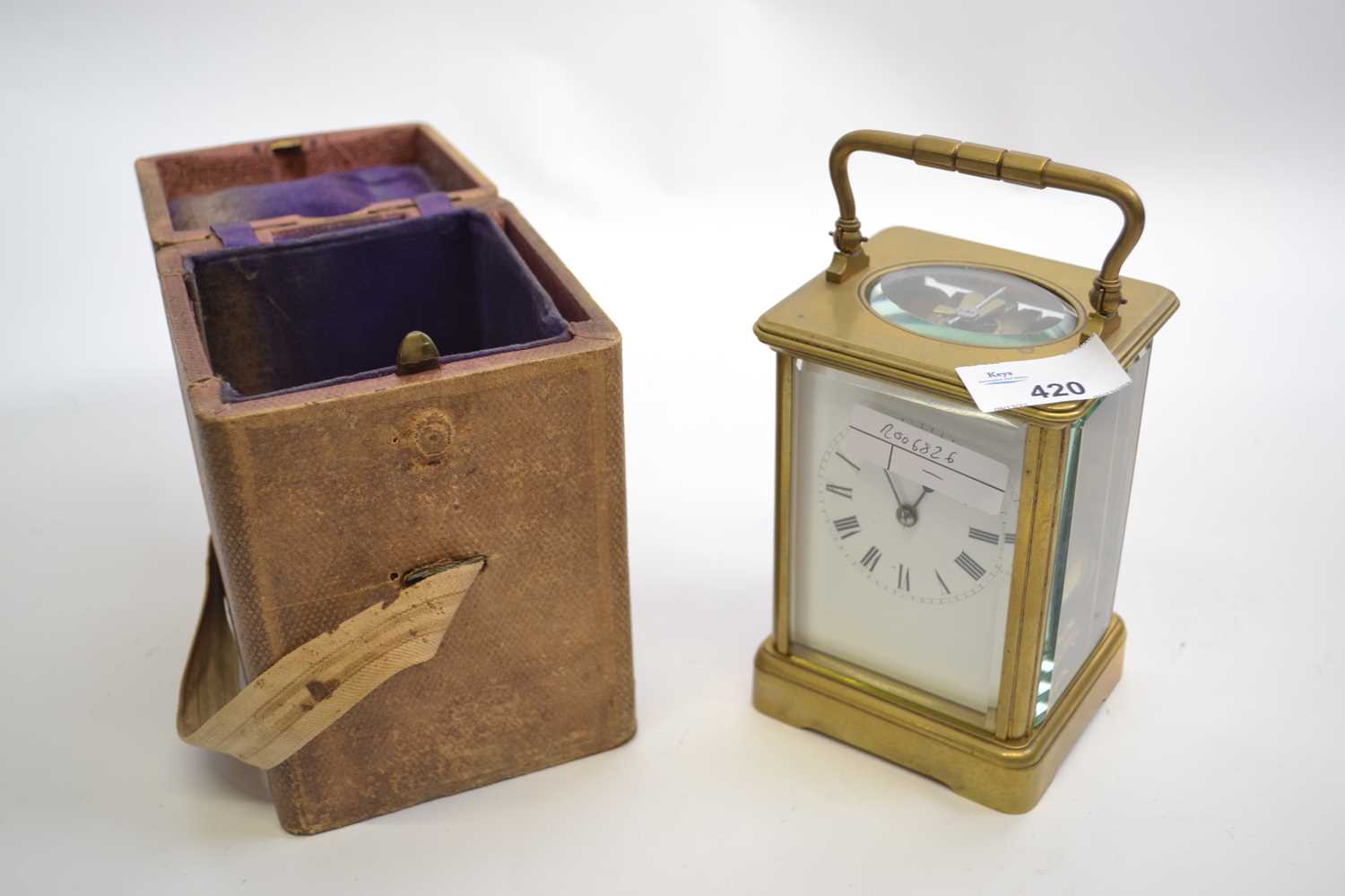 Early 20th Century brass carriage clock with white enamel dial with Roman numerals and case