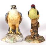 Royal Crown Derby large porcelain model of a falcon seated on rock work together with a Royal