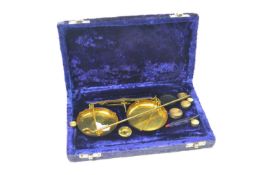 Cased set of chemist brass beam scales and weights