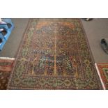 Antique Persian wool rug with tree of life and further detail of birds all within a central design