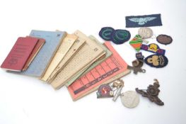 Plastic bag containing a quantity of ration cards, WWII ID cards, cap badges, medals etc