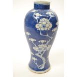 Chinese porcelain vase of baluster shape, the blue ground decorated with prunus, 22cm high