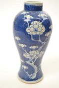 Chinese porcelain vase of baluster shape, the blue ground decorated with prunus, 22cm high