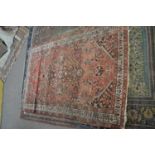 Antique Middle Eastern wool floor rug decorated with a large central geometric panel surrounded by a