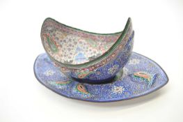 Persian style enamel boat shaped bowl with similarly decorated stand, stand 27cm long