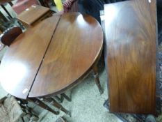 19th Century mahogany circular dining table with two extension leaves raised on turned legs with