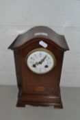 Early 20th Century mantel clock with floral decorated dial set in an arched mahogany case