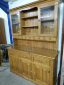 Modern pine kitchen dresser with glazed top section over a base with three doors and three