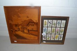 Marquetry picture of a village street scene together with a framed group of Wills cigarette cards