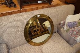 Circular brass framed wall mirror