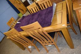 Modern light oak extending dining table together with six matching chairs, table is 180cm wide