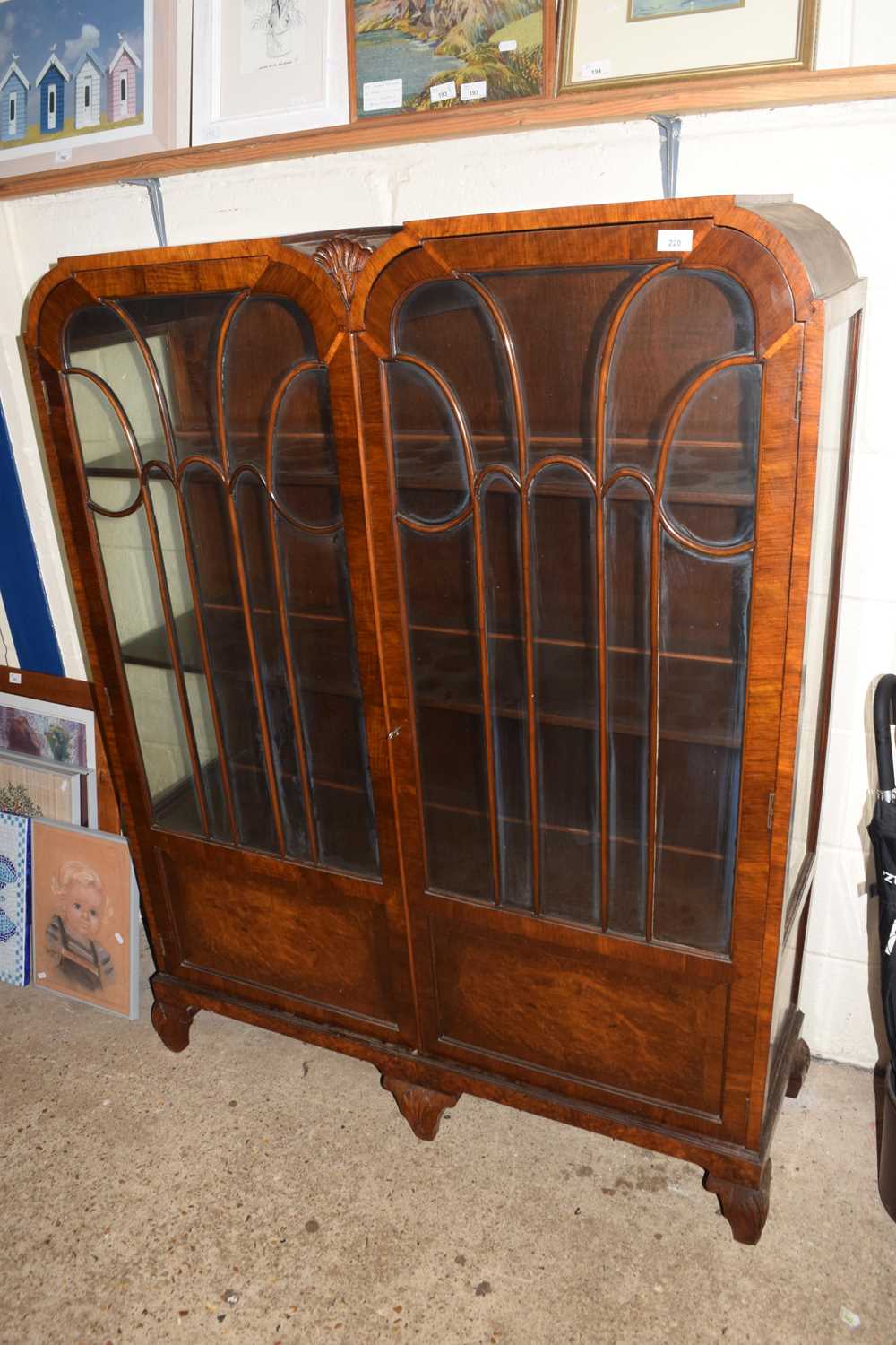 Art Deco style walnut veneered china display cabinet of double arched form, 118cm wide